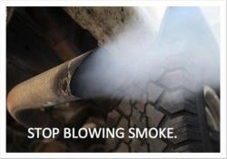 Photo of car exhaust pipe with text STOP BLOWING SMOKE.