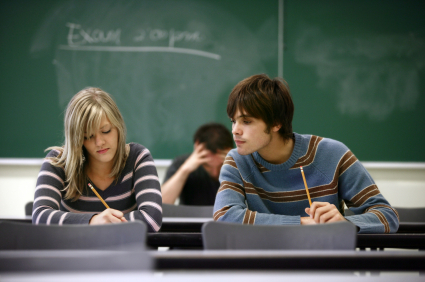 A student peering at the work of another student