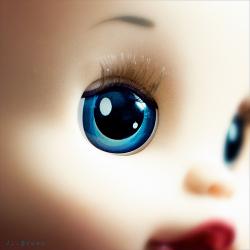 close-up photo of a doll with blue eyes