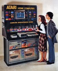 Retro image of young couple standing in front of a large Atari home computer