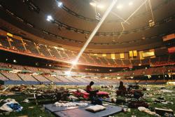 This is an image of the Superdome and survivors of Hurricane Katrina living inside of it