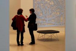 Two woman conversing in an art gallery