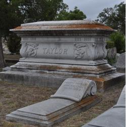 Large family memorial in rear with individual gravestone in front. 