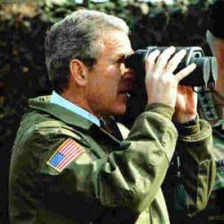 George W Bush holding binoculars